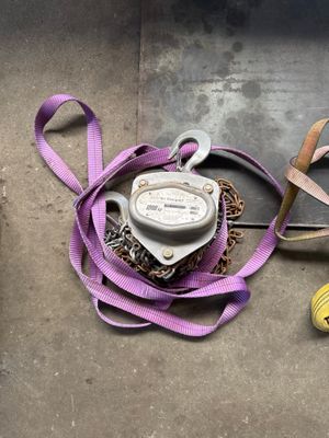 a yellow ball of yarn next to a purple ribbon