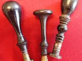 pair of antique brass candlesticks on a red background