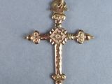 a close up of a cross on a table with a blue background