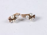 pair of pearl and gold earrings on a white surface