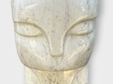sculpture of a woman ' s face made of white marble on a white background