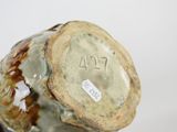 a close up of a vase with a tag on it