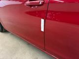 a red car that has a sticker on the side of it