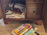 a book on the floor next to a wooden cabinet