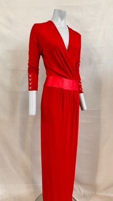 the dress is red and has long sleeves and a belt
