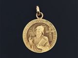 une image représentant une médaille d'or sur laquelle figure le portrait d'un homme