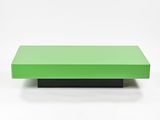 a green coffee table sitting on top of a white surface