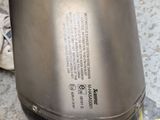 a close up view of a stainless steel kettle on the ground