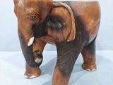 statue d'un éléphant avec ses défenses, posée sur une surface blanche