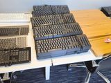 a desk with a keyboard and a laptop on top of it