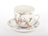 a cup and saucer on a saucer on a white surface