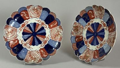 pair of japanese plates with blue, red and white designs