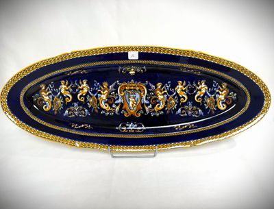 a blue and gold platter with a lion design on it