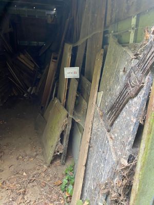 a small wooden shed with a sign on the door