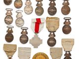 an assortment of medals and medals are displayed on a white surface