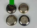 three silver metal knobs with a green stripe on a white surface