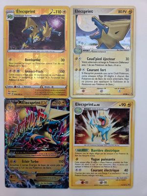 quatre cartes Pokémon posées sur une surface blanche, dont l'une au premier plan