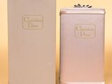 christian dior perfume bottle and box on a yellow background