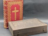 two old books sitting next to each other on a gray surface