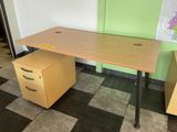 a desk with a file cabinet in the corner of the room