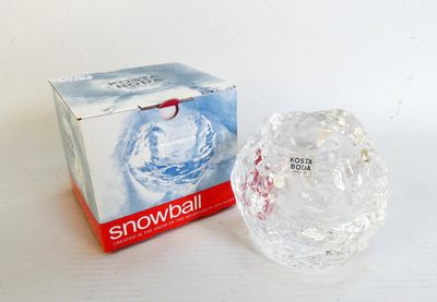 a box of snowballs sitting next to a glass ball