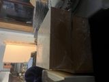 many boxes stacked on top of each other in a room
