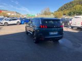 the back end of a black suv parked in a parking lot