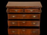 an image of a wooden chest of drawers on a black background