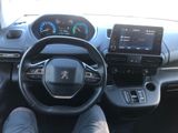 someone is sitting in the driver ' s seat of a car with their feet on the steering wheel
