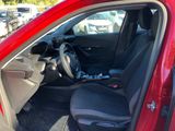 the interior of a red car with the door open and the passenger seat down