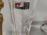 a glass vase with a sticker on it sitting on a table
