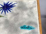 a small table with a flower painted on it