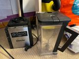 two blenders sitting on the floor next to each other