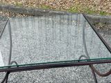 a glass table with a metal frame and a glass top