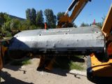 a crane that is lifting a piece of metal off of the ground