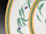 two plates with flowers painted on them on a table