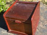 an old wooden box sitting on top of a cement slab