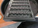a black keyboard sitting in a frying pan on a wooden table