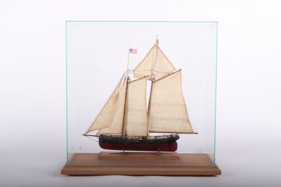 a small model of a sailboat in a glass case
