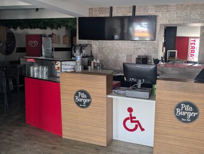 une photo d'un restaurant avec un panneau « Accès handicapés » posé sur le comptoir