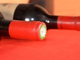 two bottles of wine sitting on a red table