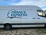 the van is parked on the side of the road in the grass
