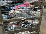 a large metal cage filled with lots of clothes