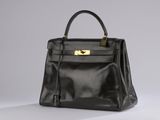 a black leather handbag on a white background