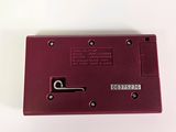 an image of a red electronic device on a white surface