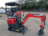 a small red excavator that is parked in the dirt