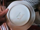 a person holding a white plate with a picture on it