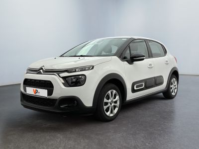a white citrole is parked in a large room