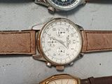 three different types of watches are lined up on a table