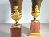two vases sitting on top of each other on a table